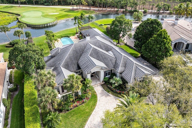 drone / aerial view featuring view of golf course and a water view