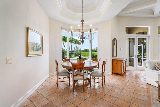 dining space featuring a notable chandelier, a raised ceiling, ornamental molding, light tile patterned flooring, and baseboards