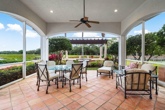 sunroom / solarium with ceiling fan