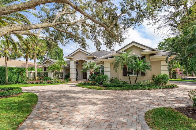 7500 Marsh Cv, Palm Beach Gardens, FL 33418 - view of front of home with curved driveway and stucco siding