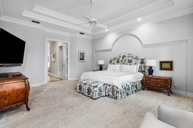 carpeted bedroom with a tray ceiling, crown molding, visible vents, a ceiling fan, and baseboards