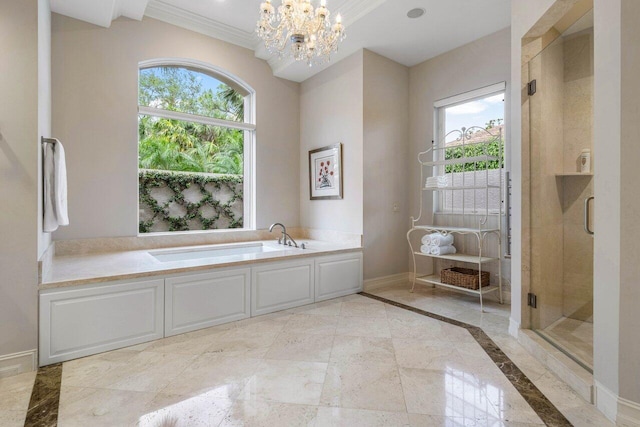 bathroom with ornamental molding, a garden tub, a wealth of natural light, and baseboards