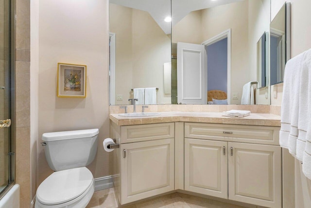 bathroom with baseboards, a shower with door, vanity, and toilet