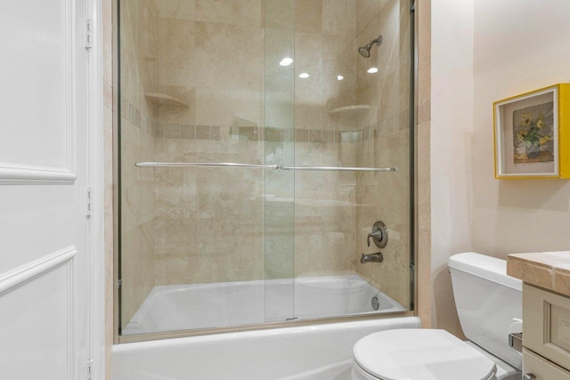 full bath featuring combined bath / shower with glass door, vanity, and toilet