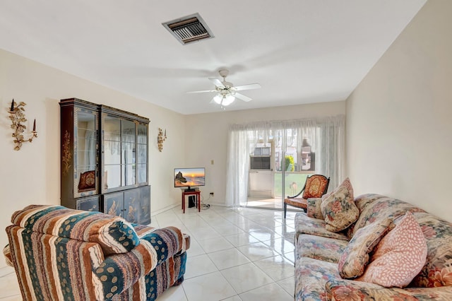 living room featuring light tile patterned floors, ceiling fan, and visible vents