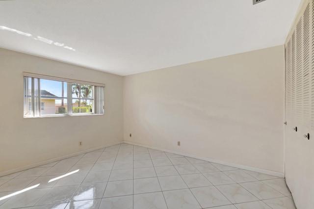 spare room featuring baseboards