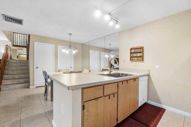 kitchen featuring light countertops, stainless steel microwave, light tile patterned flooring, and white range with electric stovetop