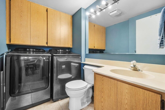 bathroom featuring washer and clothes dryer, vanity, toilet, tile patterned flooring, and visible vents