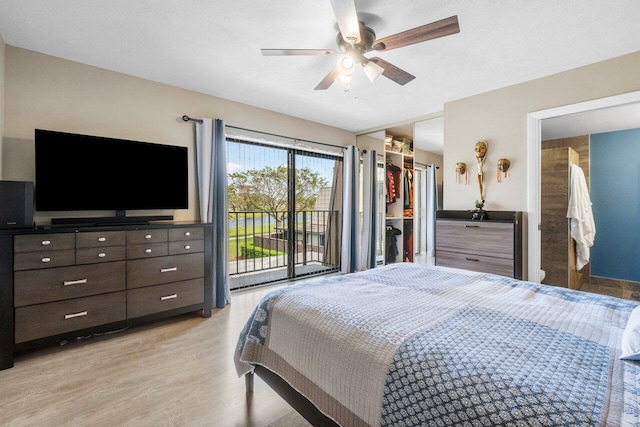 bedroom featuring access to exterior, light wood-type flooring, a spacious closet, a ceiling fan, and a closet