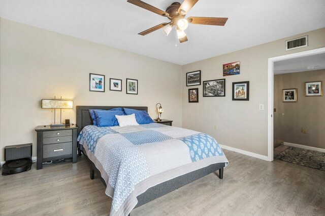 bedroom with ceiling fan, light wood-style floors, access to outside, a closet, and a walk in closet