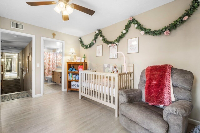 bedroom with visible vents, ceiling fan, baseboards, and wood finished floors