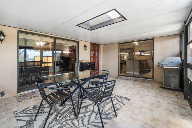 sunroom / solarium featuring a skylight