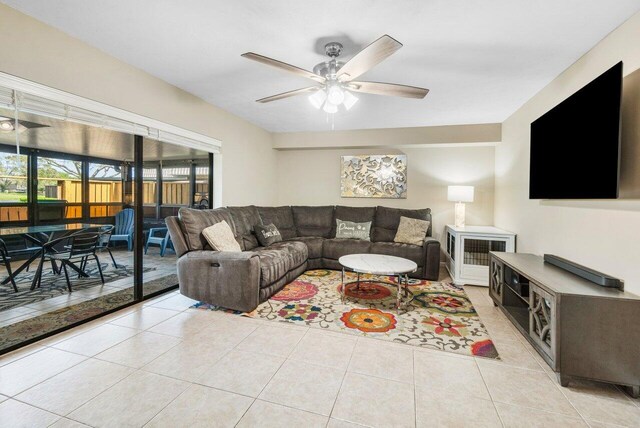 tiled living room with a ceiling fan, visible vents, stairway, and baseboards