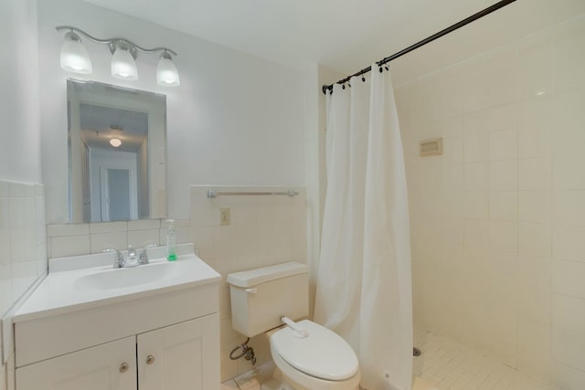 bathroom featuring a shower stall, vanity, toilet, and tile walls