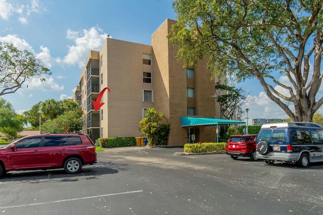 view of building exterior featuring uncovered parking