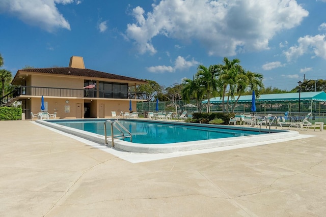 pool with fence and a patio