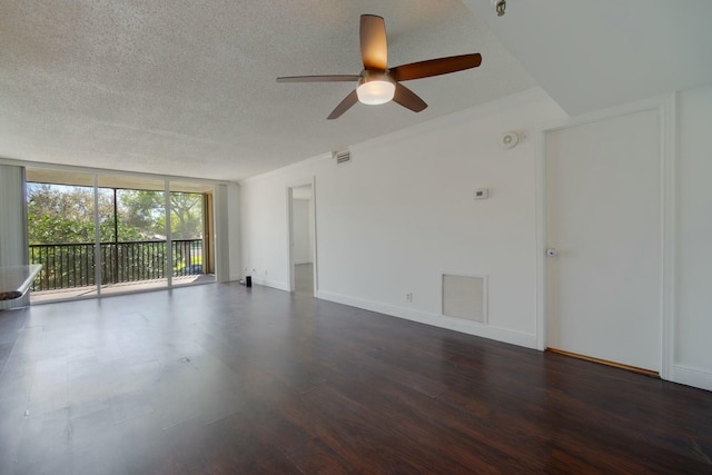 unfurnished room with baseboards, floor to ceiling windows, visible vents, and wood finished floors