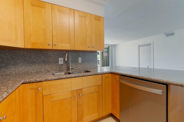 kitchen with stone counters, a sink, visible vents, stainless steel dishwasher, and backsplash