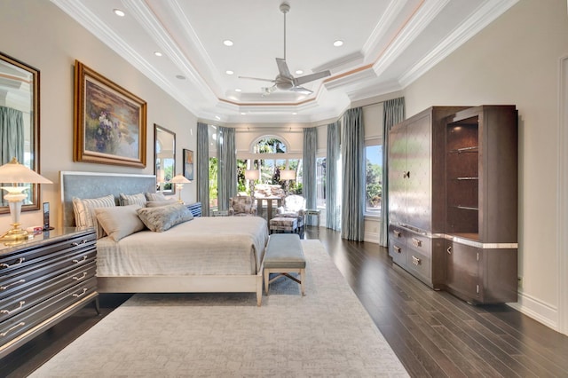 bedroom with baseboards, recessed lighting, dark wood-type flooring, crown molding, and a raised ceiling