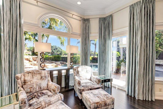 sitting room featuring dark wood finished floors and crown molding