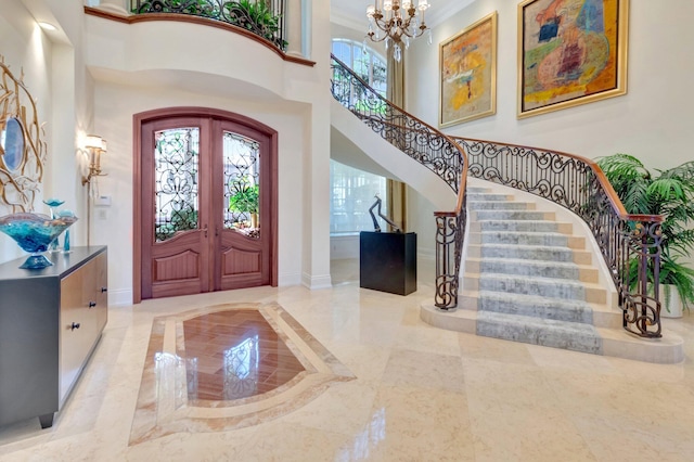 entrance foyer featuring stairway, marble finish floor, french doors, and baseboards
