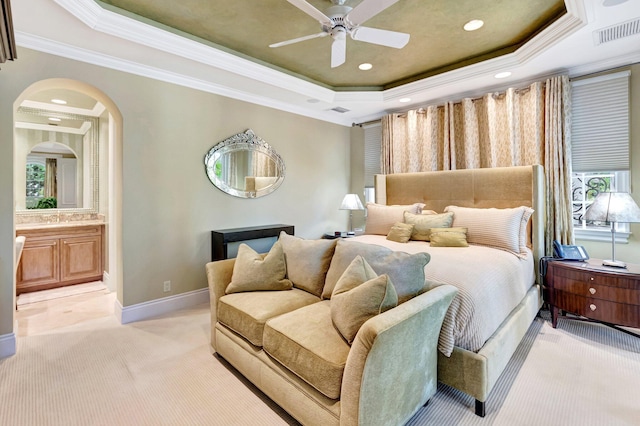 bedroom featuring baseboards, visible vents, ornamental molding, light carpet, and a raised ceiling