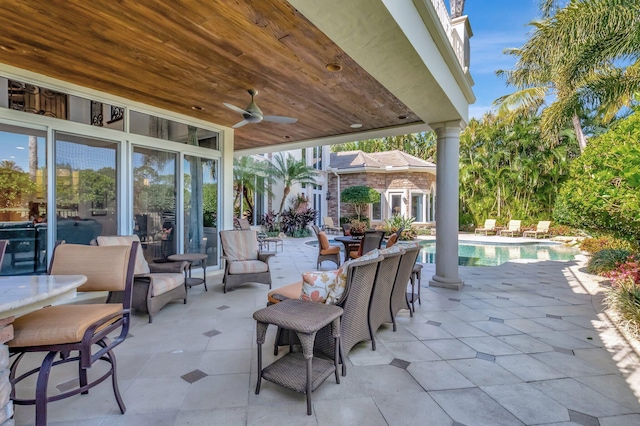 view of patio / terrace featuring an outdoor pool, an outbuilding, and ceiling fan