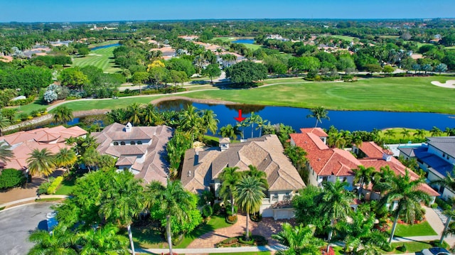 aerial view with golf course view, a residential view, and a water view