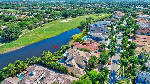 aerial view featuring view of golf course, a residential view, and a water view