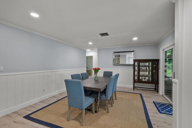 dining space with recessed lighting, wood finished floors, visible vents, ornamental molding, and wainscoting