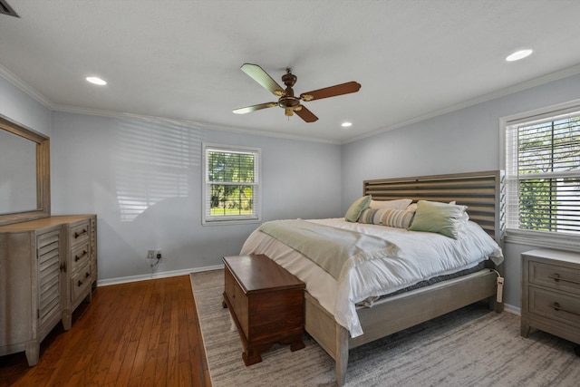 bedroom featuring multiple windows, crown molding, baseboards, and wood finished floors