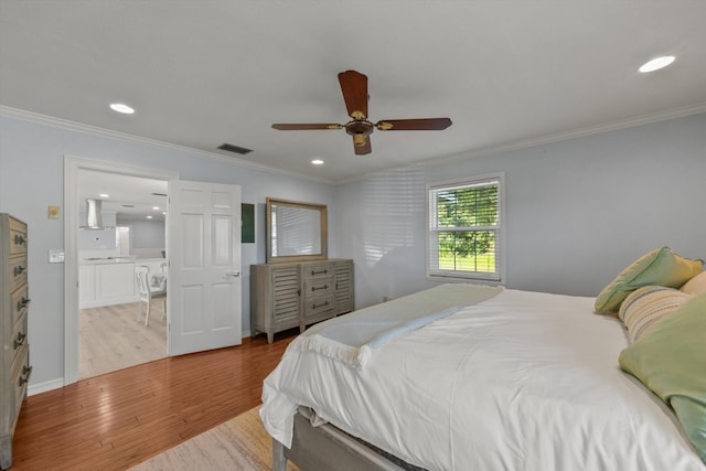 bedroom featuring ornamental molding, wood finished floors, and recessed lighting