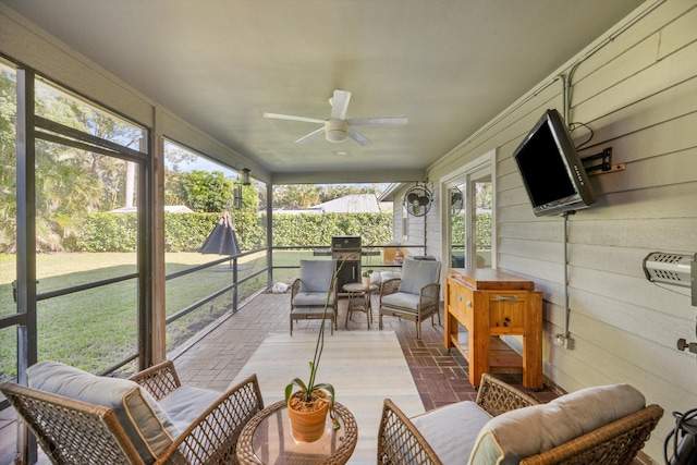 sunroom with a ceiling fan