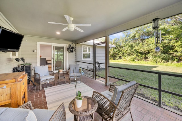 sunroom with a ceiling fan