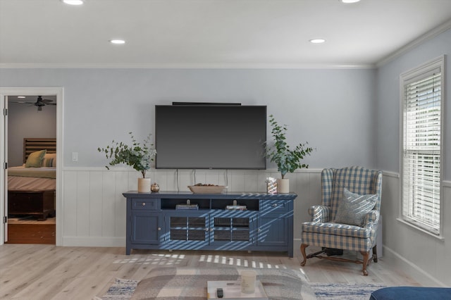 living area featuring recessed lighting, wainscoting, crown molding, and wood finished floors