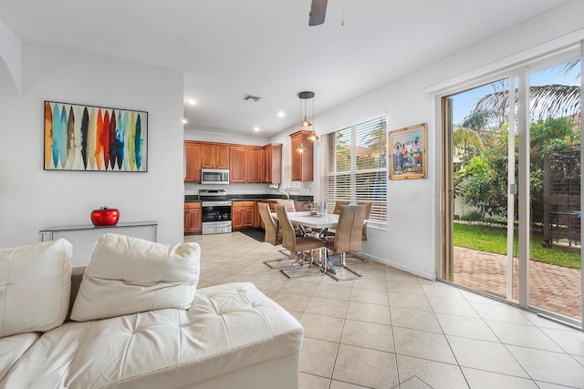 living area featuring light tile patterned floors, recessed lighting, visible vents, ceiling fan, and baseboards