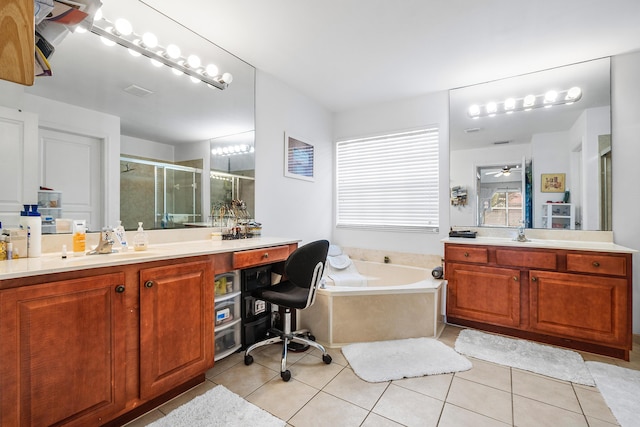 bathroom with a sink, a garden tub, tile patterned flooring, a shower stall, and two vanities