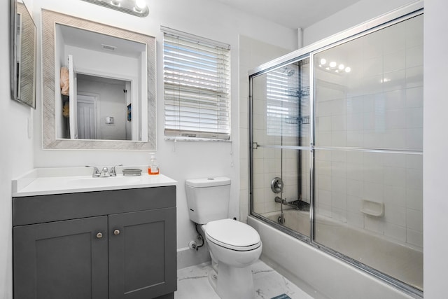 bathroom with marble finish floor, shower / bath combination with glass door, toilet, vanity, and baseboards