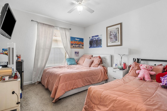 bedroom with light carpet, ceiling fan, and baseboards