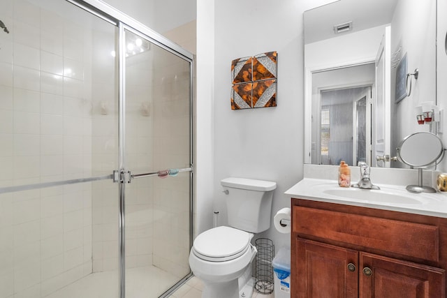 full bathroom with a stall shower, visible vents, vanity, and toilet