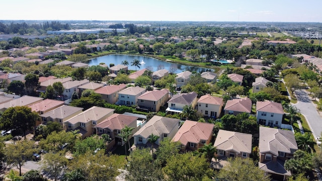 birds eye view of property with a water view and a residential view