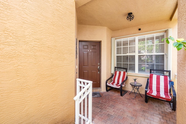 entrance to property featuring stucco siding