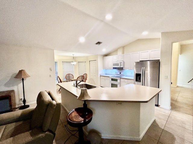 kitchen with lofted ceiling, visible vents, white cabinetry, a sink, and white appliances