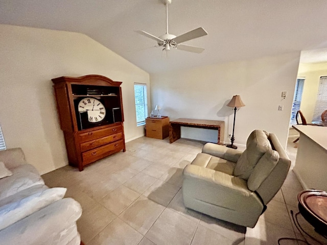 living room with lofted ceiling, ceiling fan, and light tile patterned flooring