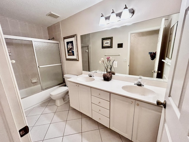 bathroom featuring double vanity, a sink, visible vents, and tile patterned floors