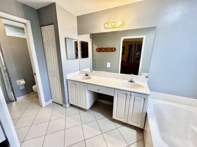 full bath with double vanity, a sink, a bath, and tile patterned floors