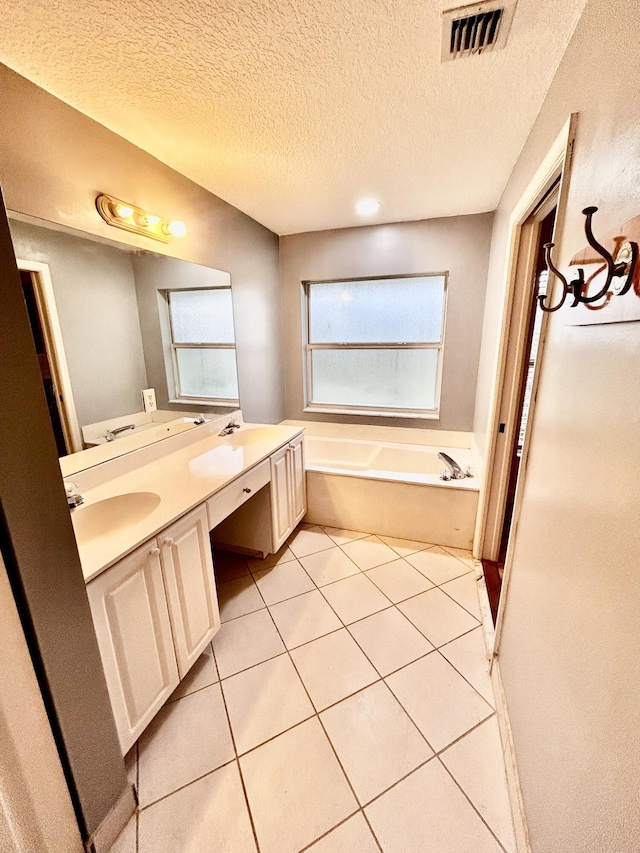 full bath with double vanity, visible vents, tile patterned floors, a sink, and a bath