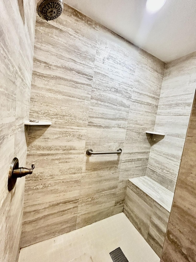 full bath with a tile shower