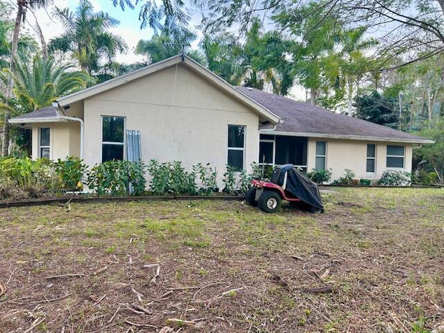 back of house featuring stucco siding