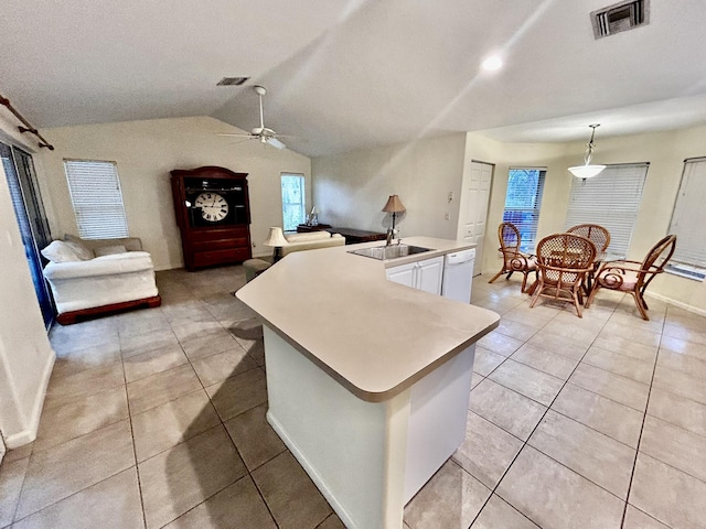 kitchen featuring white cabinetry, white dishwasher, visible vents, and vaulted ceiling